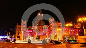 Cibeles palace illuminated at night in Madrid, Spain.