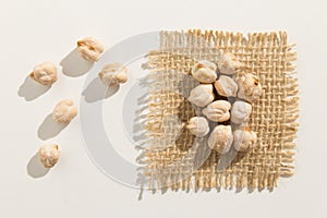 Chickpeas legume. Close up of grains spread over white table. photo