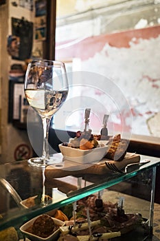 Cichetti and wine at a Venetian ostreria photo