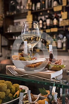 Cichetti and wine at a Venetian osteria photo