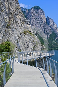 Bicycle road and foot path over Garda lake with beautiful landscape scenery at Limone Sul Garda - travel destination in Brescia, I photo