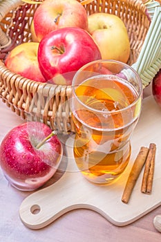 Cider - alcohol hot apple drink and apples on wooden table