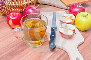 Cider - alcohol hot apple drink and apples on wooden table