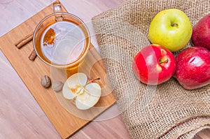 Cider - alcohol hot apple drink and apples on wooden table. Top view