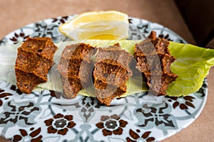 Cig Kofte raw meatball in Turkish with lettuce, traditional Turkish cuisine photo