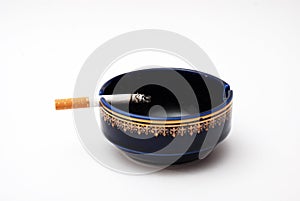 Cigarette in blue ash tray