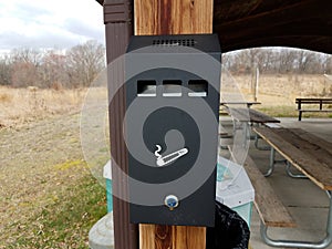 cigarette disposal can or trash can on post in park