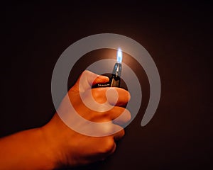 Cigarette lighter igniting by a hand