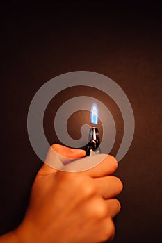 Cigarette lighter igniting by a hand