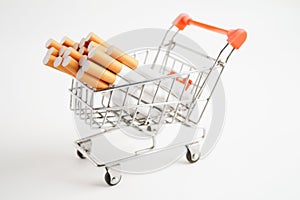 Cigarette in shopping cart, cost, trading, marketing and production, No smoking concept