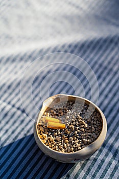 Cigarette stub in sand bucket ashtray