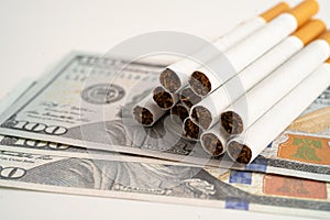 Cigarette on US dollar banknotes, cost, trading, marketing and production, No smoking