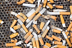 Cigarettes in a big iron ashtray
