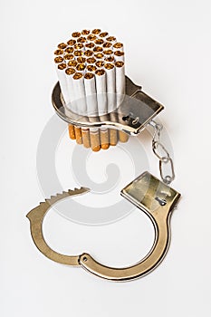 Cigarettes and handcuffs - smoking addiction concept