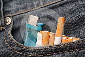 Cigarettes and lighter in pocket of jeans