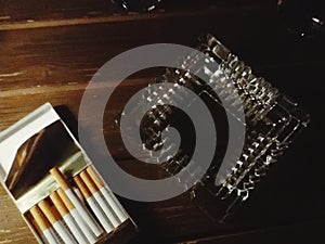 Cigars and ashtray on table.