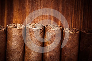 Cigars on wooden background