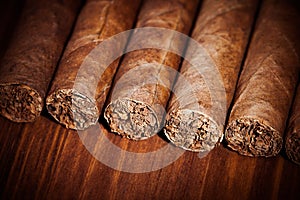 Cigars on wooden background photo