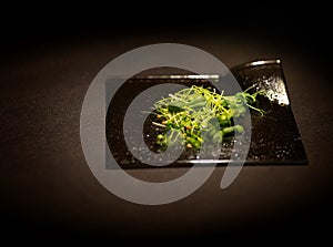 Cilantro, sunflower, micro onion, peas. Micro greens citi - farms. In plate a braun background photo