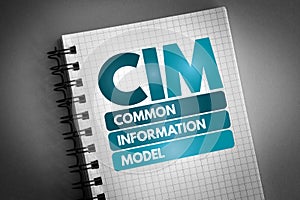CIM - Common Information Model acronym on notepad, concept background