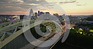 Cincinnati city, Ohio, USA with highway traffic driving cars in downtown district. American city skyline with brightly
