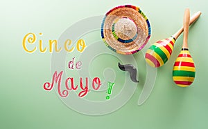 Cinco de Mayo holiday background made from maracas, mexican blanket stripes or poncho serape and hat on pastel background