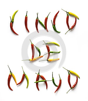 Cinco De Mayo letters from red, green and yellow hot little chili peppers isolated on the white background