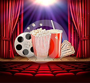 Cinema background with a film reel, popcorn