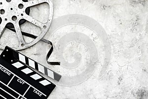 Cinema background with movie clapperboard and film reel