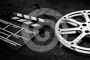 Cinema background with movie clapperboard and film reel