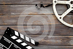 Cinema background with movie clapperboard and film reel