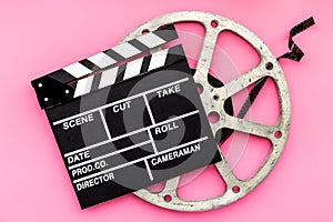 Cinema background with movie clapperboard and film reel