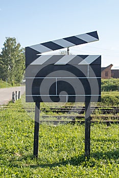 Cinema Concept Big Size Movie Clapper at Ourside on Green Grasses at Outside