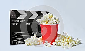 Cinema concept movie clapperboard with popcorn