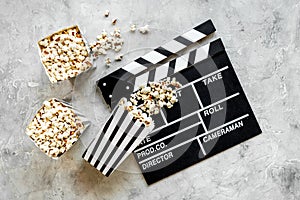 Cinema concept. Popcorn with film reel strip and clapper board