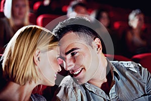 Cinema, date and happy couple watching movie, smile and romantic night together for show. Theater, man and woman with