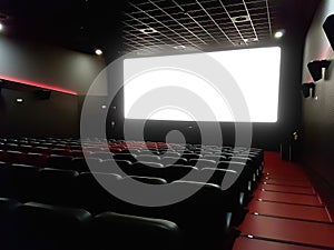 Cinema interior of movie theatre with empty red and black seats