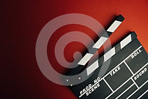 Cinema minimal concept. Watching film in the cinema. clapper board on red background.