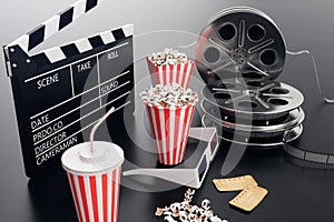 Cinema movie watching. Composition with 3d glasses, movie clapper, film reel, popcorn and filmstrip Cinema concept