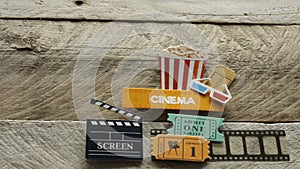 Cinema sign with popcorn bucket 3d glasses movie tickets big screen opened box on wood background