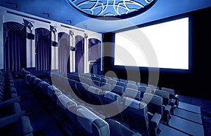 Cinema theater showing empty white movie screen.