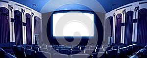 Cinema theater showing empty white movie screen.