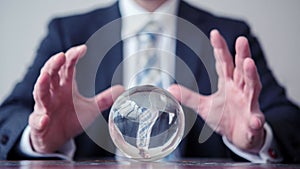 Cinemagraph of a business man looking at a crystal ball