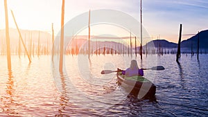 Cinemagraph continuous loop animation of girl kayaking during sunrise