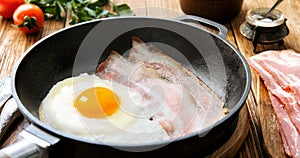 Cinemagraph - Cooking egg with bacon in a frying pan.