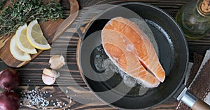 Cinemagraph - Cooking salmon steak fish in a frying pan.