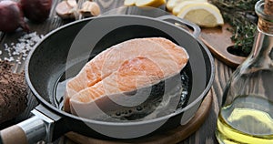 Cinemagraph - Cooking salmon steak fish in a frying pan.