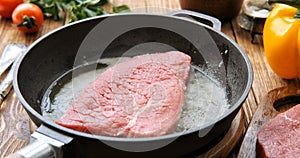 Cinemagraph - Cooking steak in a frying pan.