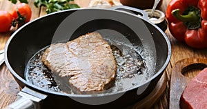 Cinemagraph - Cooking steak in a frying pan.