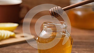 Cinemagraph- Drops of honey dripping in the jar with honey.